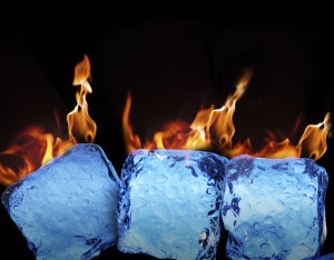 Burning ice cubes on black background